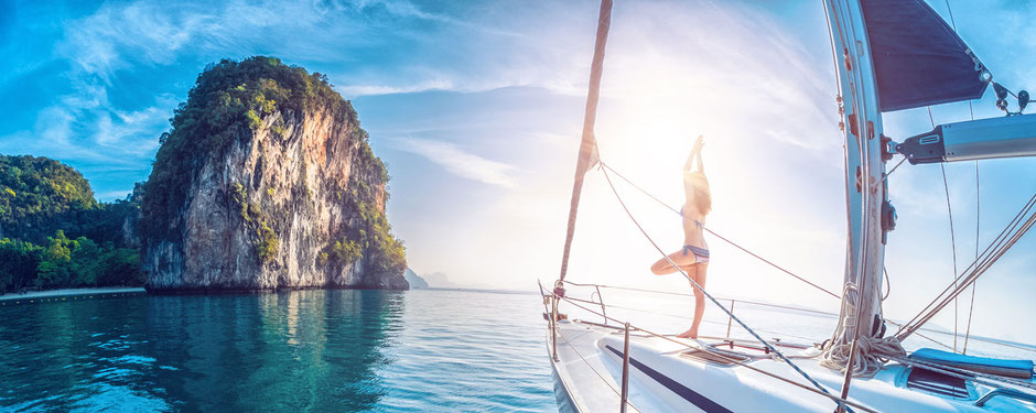 Yoga pose aboard a sailing yacht at sunset
